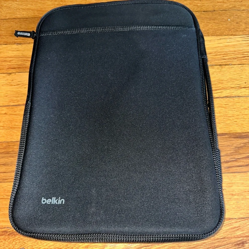 Black Belkin laptop sleeve with a zipper pocket on the front.